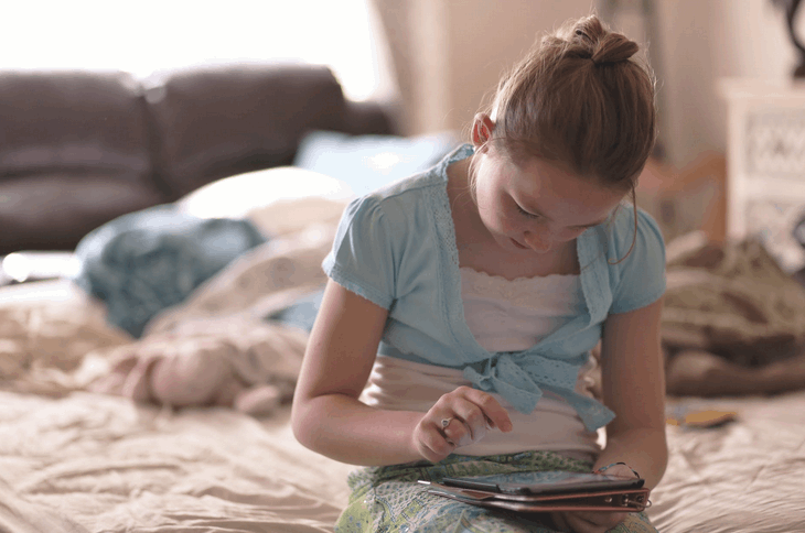 little girl on tablet