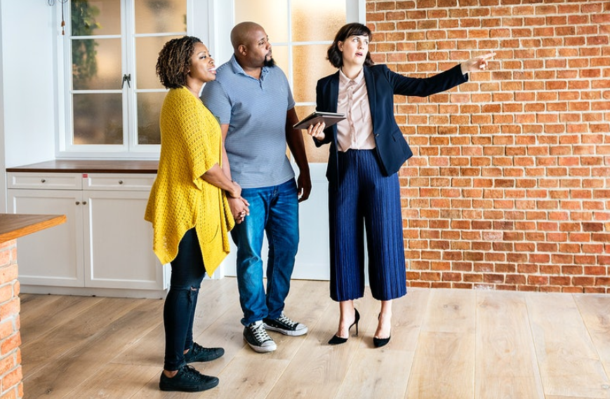 black couple discussing with an agent